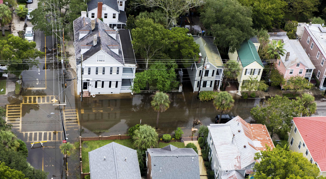 Aerial view of a flooded Charleston neighborhood of residential homes and apartments.
