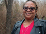 Portrait of Norfolk homeowner Karen Speights smiling with sunglasses, a heart-shaped necklace, and a leather jacket.
