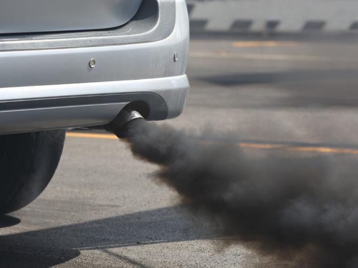 Pollution billows out of a vehicle's tailpipe.