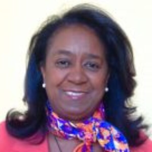 Portrait of Deborah Kennedy Kennard in a colorful scarf.