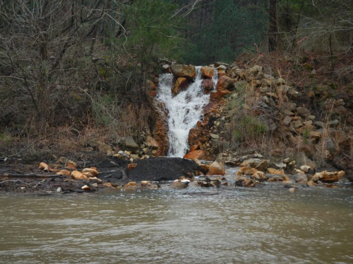 A waterfall of acid mine drainage from the Maxine Mine site pollutes the Locust Fork of the Black Warrior River.