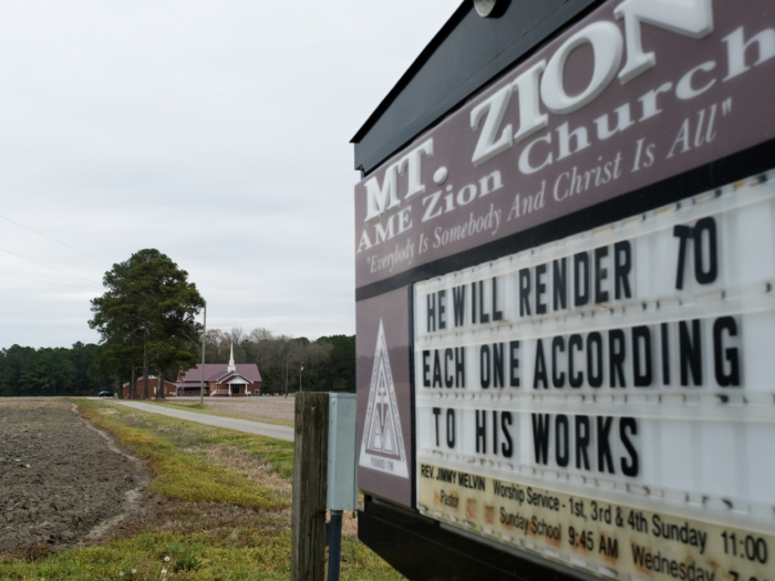 A sign outside a church says, "He will render each one according to his works."